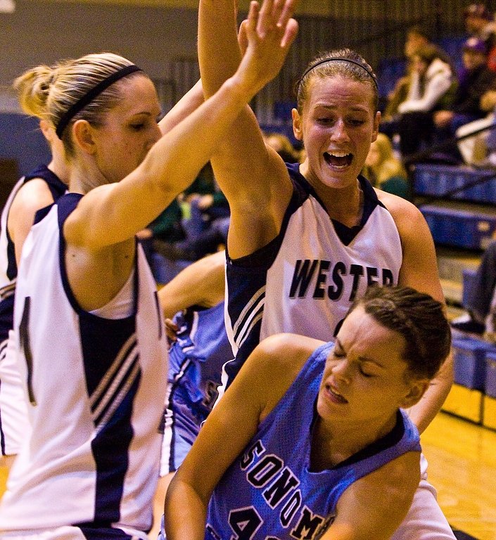 Western players Willow Cabe and Jessica Summers press Sonoma State center Christy Shreve as she attemps to pass the ball. Photo by Jon Bergman | WWU intern