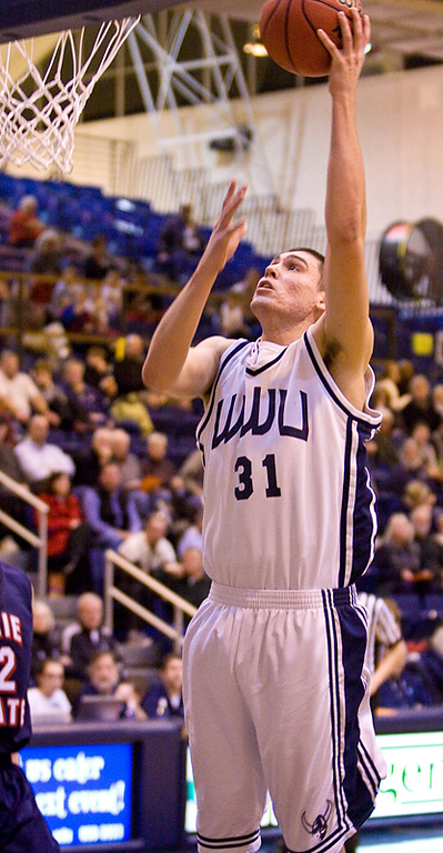 Western center Zach Bruce scores two of his six total points with an easy layup. Bruce also pulled in three rebounds and one assist during the game. Photo by Jon Bergman | WWU intern