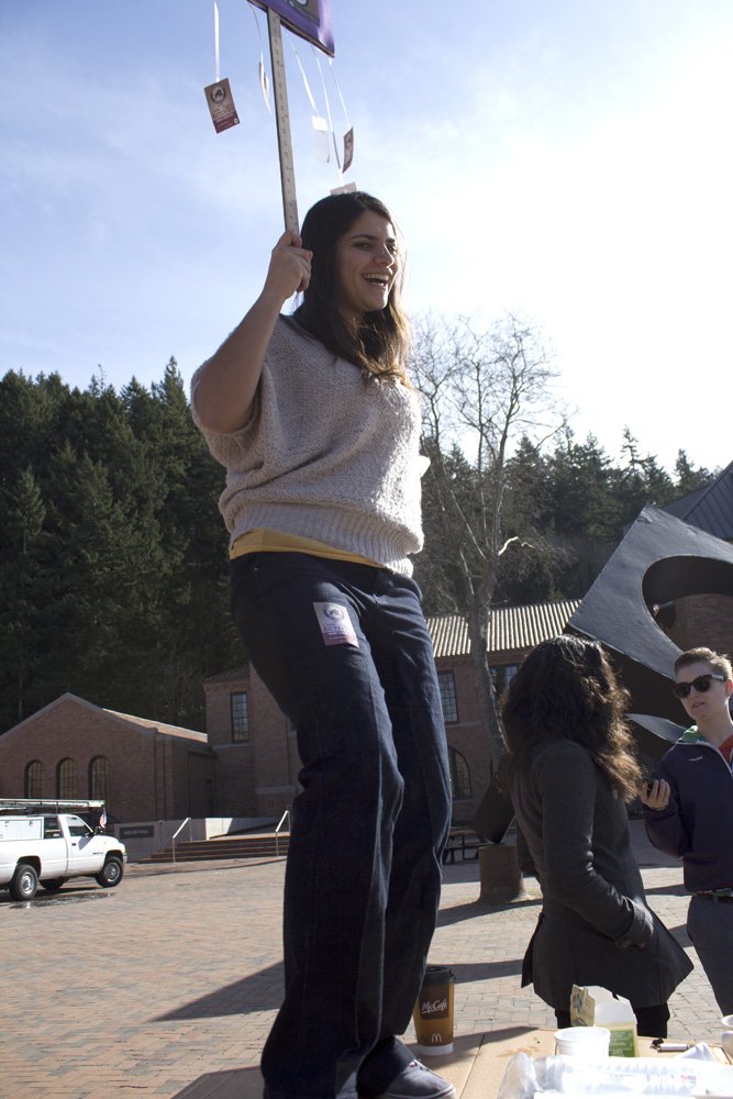 Social Issues Resource Center coordinator Saraswati Noel dances on a table in Red Square while promoting an event on Feb. 27. As part of Activism Week, the SIRC is bringing Ericka Huggins, a female leader of the Black Panthers, to campus for a discussion 