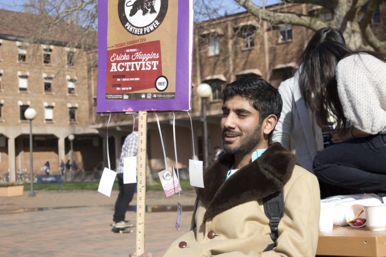 Western student Jibran Al-Arif helps promote an event for the Social Issues Resource Center in Red Square as a part of Activism Week at Western. Photo by Jeremy Smith | University Communications intern