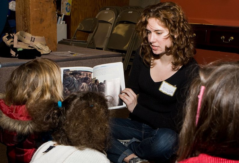 Western Washington University sophomore Jessica Bennett, a sociology and elementary education major, reads to a group of children in honor of Martin Luther King Jr. at Village Books in Fairhaven on Monday, Jan. 18. Photo by Jon Bergman | University Commun