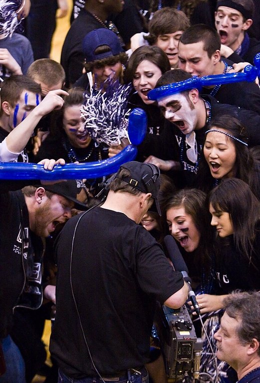 Western fans swarm a Fox Sports Northwest camera man to cheer the Vikings' victory over top rival Central Washington University Sunday at Carver Gym. Photo by Jon Bergman | University Communications intern