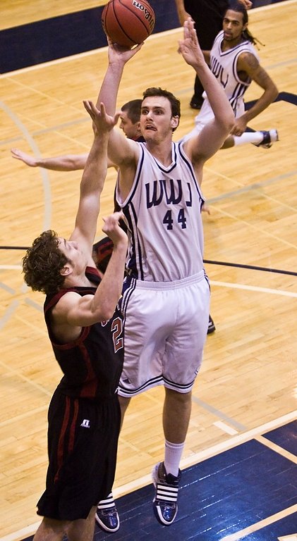 David Vanderjagt throws up a jump shot over Central’s Roby Clyde during the first-half of the Vikings victory. Vanderjagt finished the night with seven points, four rebounds and five blocks. Photo by Jon Bergman | University Communications intern