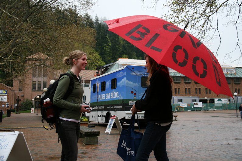 Western Washington University freshman Rosalee Daughtry, 19, right, chats with WWU junior Leanne Sebren in Red Square on Tuesday, April 19. Sebren said she usually gives blood but couldn't this year because of a piercing she recently received. Photo by Da