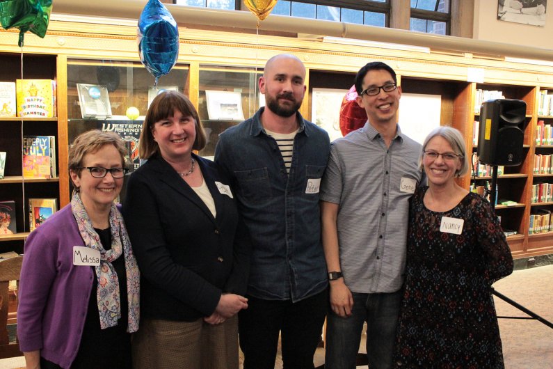 The conference’s four authors pose for a picture with event coordinator Nancy Johnson in Wilson Library on Friday. Photo by Dylan Nelson / WWU Communications and Marketing intern