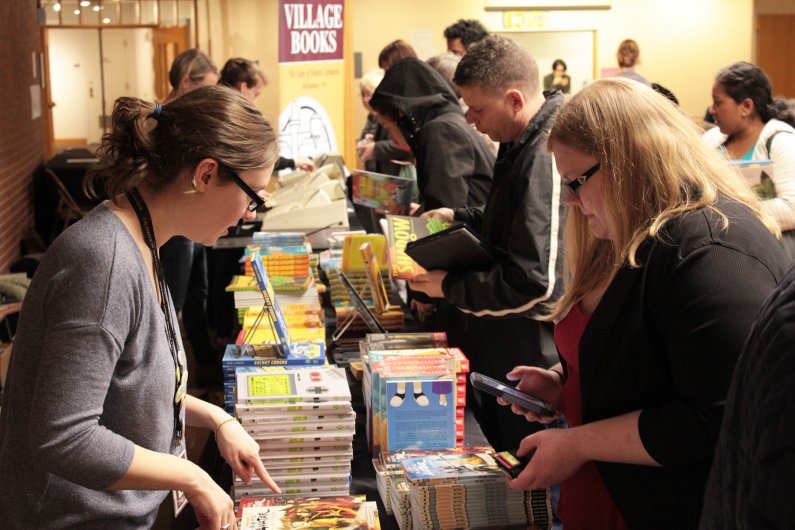 Attendees buy copies of the books written by Peter Brown, Melissa Sweet, Gene Luen Yang and Cynthia Lord. Photo by Dylan Nelson / WWU Communications and Marketing intern