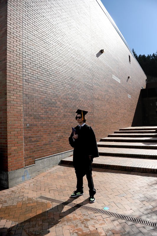 Graduating senior Eduard Raisters poses for photos after commencement on March 19, 2011. Photo by Dan Levine