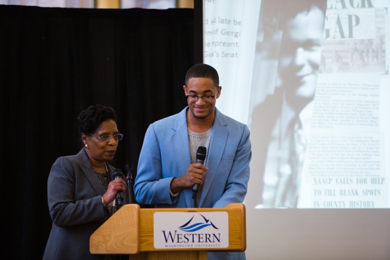 Renee Collins, left, Western's associate dean of students, and WWU student Jordan Butler, right, kick off Tuesday's MLK ceremony in the Western Libraries Reading Room. Photo by Rhys Logan / WWU