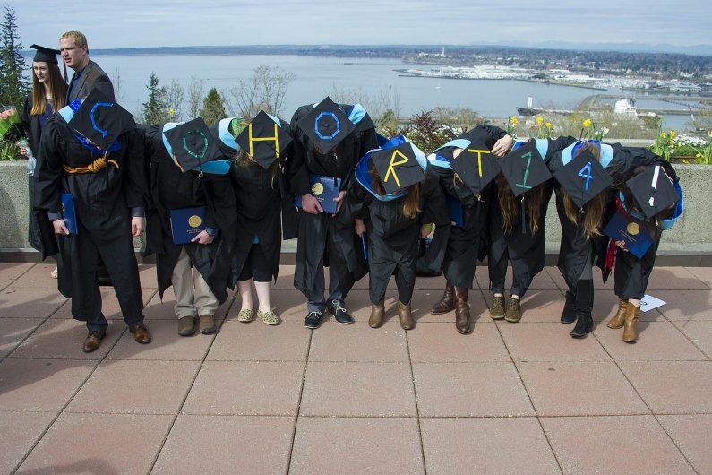 Graduates in the Master's in Environmental Science program -- Cohort 14, they call themselves -- pose for a group shot on the Performing Arts Center Plaza Saturday at WWU's winter commencement. Photo by Dan Levine / for WWU