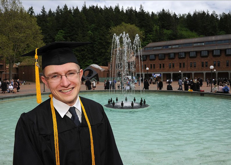 Graduate Tim Mesikepp poses for a photo in front of Fisher Fountain in Red Square after commencement at WWU June 11, 2011. Photo by Dan Levine | for WWU