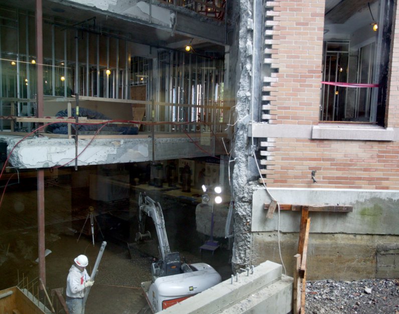 In this scene seen from the inside of Miller Market, construction workers continue the renovations of the completely gutted 1940s wing of Miller Hall. Here, they're down in the basement. Photo by Matthew Anderson | WWU