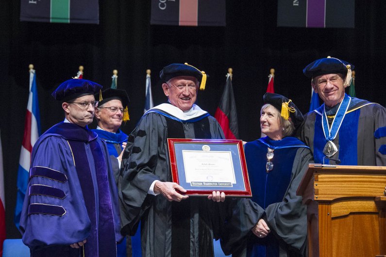 Ralph Munro, former Washington Secretary of State, receives an honorary doctorate degree at one of three commencement ceremonies at WWU’s Performing Arts Center Mainstage March 19. Photo by Dan Levine / for WWU