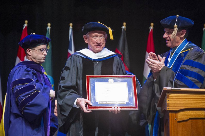Ralph Munro, former Washington Secretary of State, receives an honorary doctorate degree at one of three commencement ceremonies at WWU’s Performing Arts Center Mainstage March 19. Photo by Dan Levine / for WWU