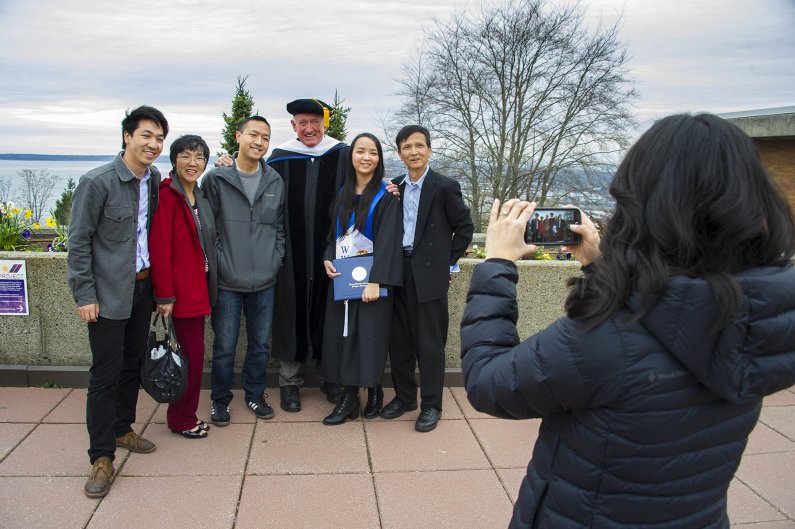Ralph Munro poses with a family celebrating their daughter Alisa Tien's WWU graduation March 19. Alisa's mom, Bea (wearing red) worked for Munro in the Secretary of State's office 35 years ago. Photo by Dan Levine / for WWU