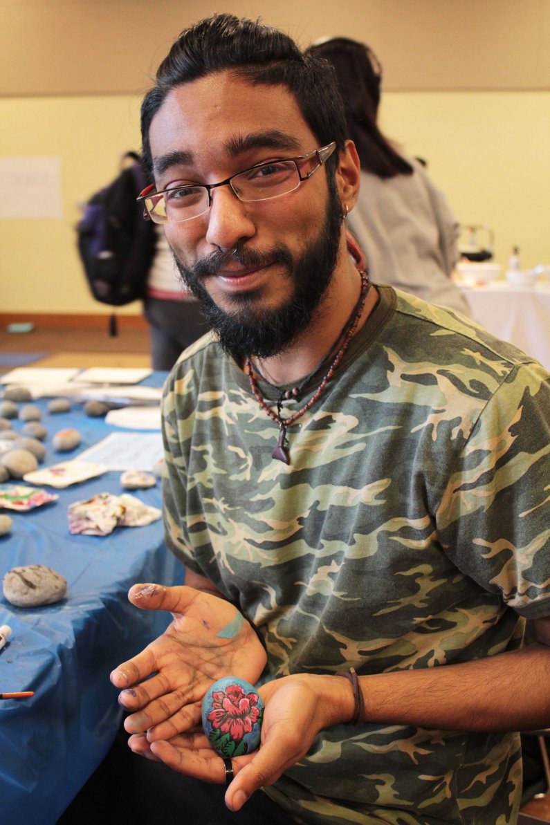 AS Social Issues Resource Center Outreach Coordinator Wayne Rocque shows off one of the rocks he painted. Photo by Dylan Nelson / WWU Communications and Marketing intern
