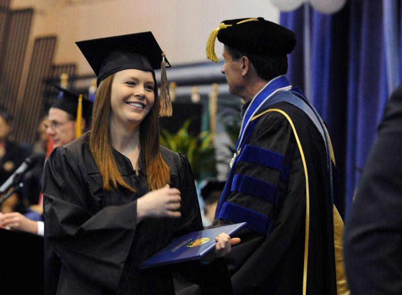 Sarah Olson, who was the commencement ceremony's student speaker, receives her diploma from WWU President Bruce Shepard. Photo by Dan Levine
