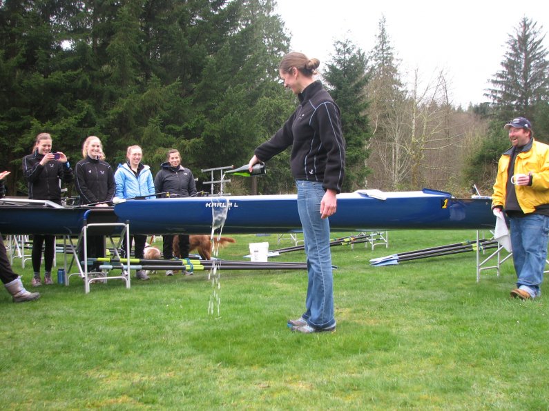 Karla Landis, a WWU alumna and former assistant coach and rower for WWU, christens the "Karla L," Western's newest four-person shell. Courtesy photo