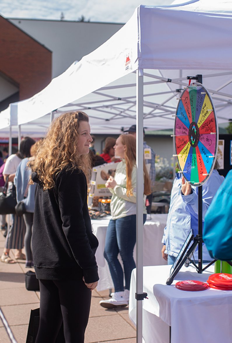 A Western student watches a spinning wheel to see which prize she will win at a booth at the WWU AS Fall Info Fair on Sep 24.