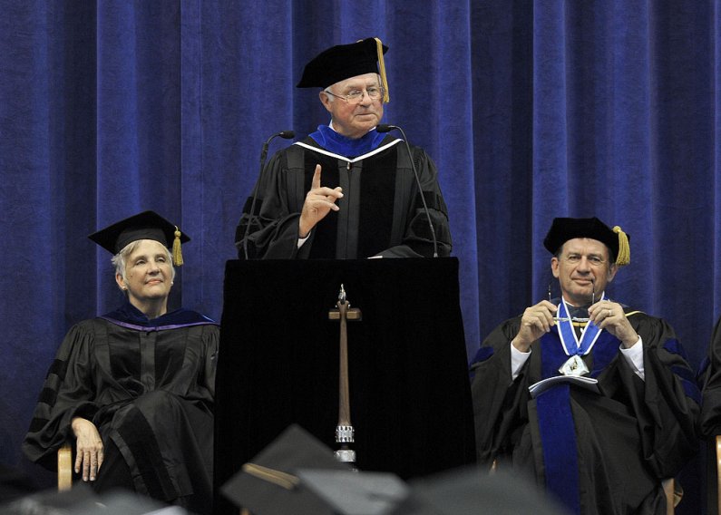 Bill Kindler, a 1965 graduate of Western Washington University, speaks at WWU commencement June 11, 2011. Seated behind Kindler are provost Catherine Riordan and president Bruce Shepard. Photo by Dan Levine | for WWU