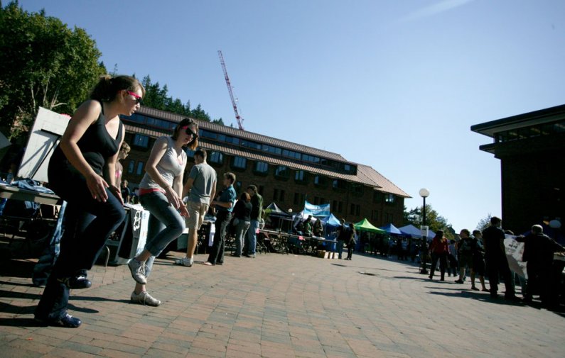 Caitlyn Beardsley, left, and Margaret Emma Butterworth, both members of the Step To This club at Western Washington University, practice a few routines during the Red Square Info Fair on Sept. 21, 2010. Photo by Matthew Anderson | University Communication