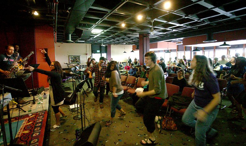 Members of The Prime Time Band dance with audience members during the group's performance Wednesday, July 20, in the Underground Coffeehouse at Western Washington University. Photo by Matthew Anderson | WWU