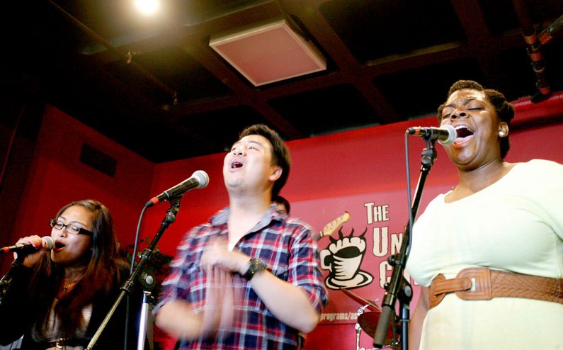 From left, Jill Quinto, Justin Gipaya and Rashawn Scott provide vocals for The Prime Time Band during the group's summer noon concert Wednesday, July 20, in the Underground Coffeehouse at Western Washington University. Photo by Matthew Anderson | WWU