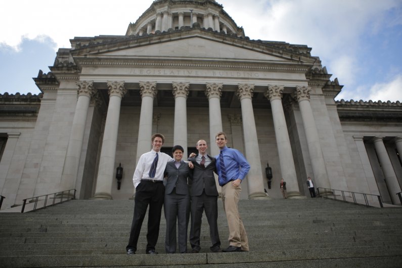Student lobbyists Michael Lang, Rebekah Hook, Colin Watrin and Mike Pond pose in front of the State Capitol building in Olympia. Photo by Alex Roberts | University Communications intern