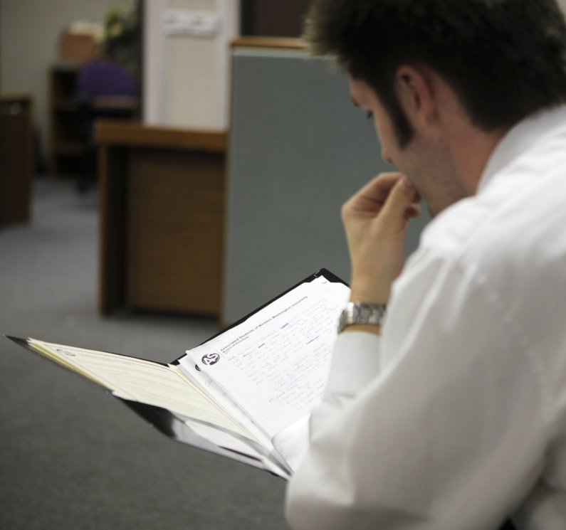 Western senior Michael Lang studies his notes prior to a meeting with state representatives. Photo by Alex Roberts | University Communications intern