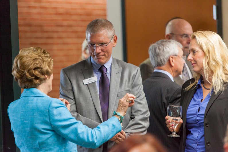 Steven Hollenhorst, dean of Huxley College of the Environment at Western Washington University, chats at an event on Wednesday, July 17, announcing Western's new partnership with OC to provide bachelor's degree programs on the Kitsap and Olympic peninsula