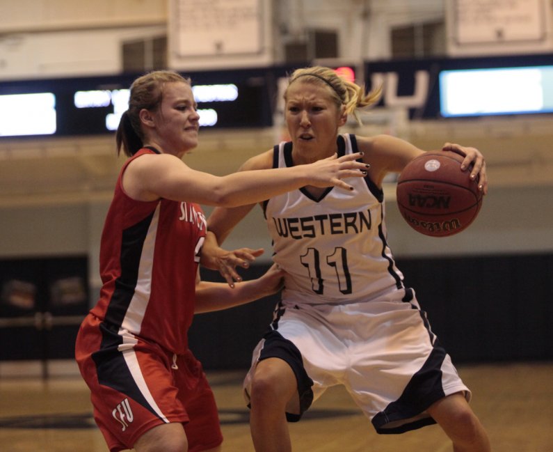 Senior Megan Pinske tries to force her way through the Simon Fraser defense, during the opening round of the GNAC Women's Basketball tournament, Monday, Feb. 28. Photo by Alex Roberts | University Communications intern
