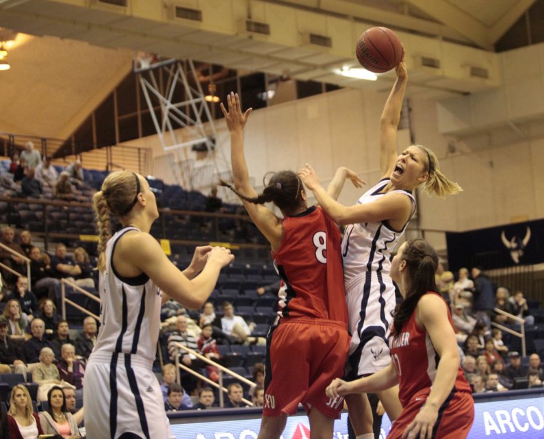 Senior Megan Pinske tries to force her way through the Simon Fraser defense, during the opening round of the GNAC Women's Basketball tournament, Monday, Feb. 28. Photo by Alex Roberts | University Communications intern
