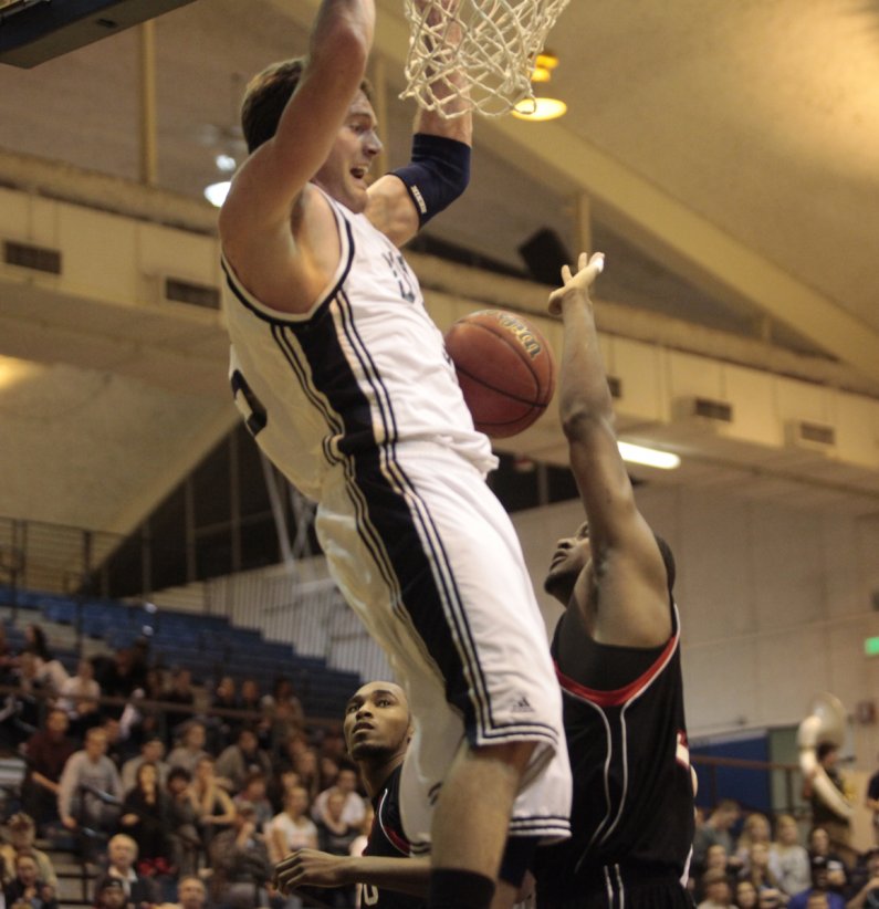 Junior Dan Young goes for a dunk during the opening round of the GNAC Men's Basketball tournament, Monday, Feb 28. Photo by Alex Roberts | University Communications intern