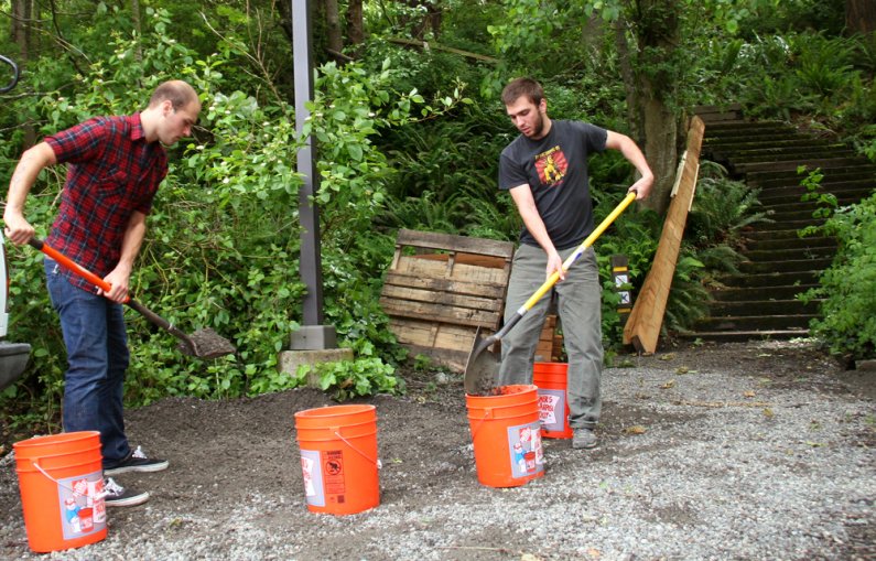 Western juniors Ian Lucas and John Herbert shovel gravel into 5-gallon buckets in front of the site of a second stairway to be built by the 2010 fall block of Geology 417D, Outdoor Science Learning Resources. Photo by David Gonzales | University Communica