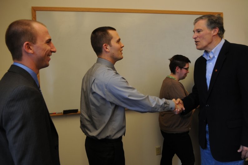 U.S. Representative Jay Inslee shakes hands with A.S. President Colin Watrin, left, and students Phil Coomes and Lisa Pubigee during a visit to Western Thursday, April 21. Photo by Daniel Berman/University Communications intern