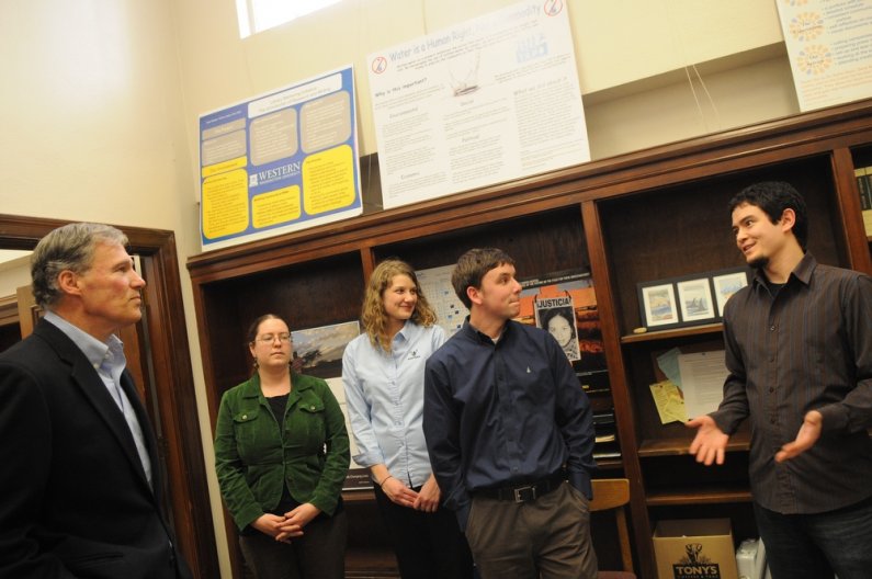 U.S. Representative Jay Inslee speaks to students, including, L-R, Hannah Hess, Beth Parker, Shawna Held, Matt Stokes, Gabriel Fauber and director Tim Costello, during a tour of the Students in Service Learning office at Western Thursday, April 21. Photo 