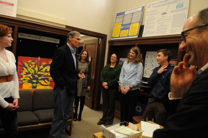 U.S. Representative Jay Inslee speaks to students, including, L-R, Keegan Ryan, Hannah Hess, Beth Parker, Shawna Held, Matt Stokes, Gabriel Fauber and director Tim Costello, during a tour of the Students in Service Learning office at Western Thursday, Apr