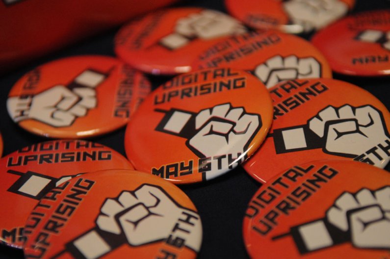 Promotional buttons were given away at the Techtonic 2011 Digital Uprising event Friday, May 6 in V.U. 565. The event brought national technology and electronics companies such as Adobe, Apple, Dell, HP and Microsoft  to Western for a day of demos and pro