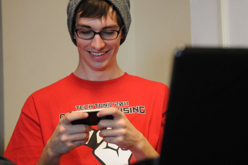 A student passes time playing video games on his iPhone during the Techtonic 2011 Digital Uprising event Friday, May 6 in V.U. 565. The event brought national technology and electronics companies such as Adobe, Apple, Dell, HP and Microsoft  to Western fo