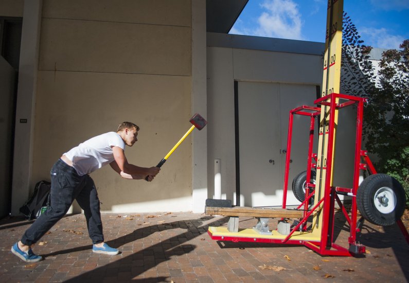 Maxwell Hand hefts a large mallet while playing one of the many carnival games offered at The Fair on Wednesday Oct. 14, 2015. Photo by Kyra Betteridge / WWU Communications and Marketing intern