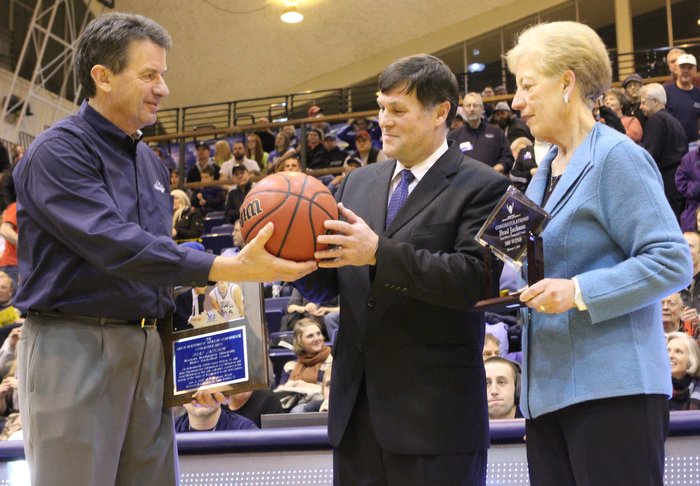 Western Washington University men's basketball coach Brad Jackson, center, receives an award commemorating his 500th career victory from President Bruce Shepard, left, and Athletic Director Lynda Goodrich before Wednesday night's basketball game against C