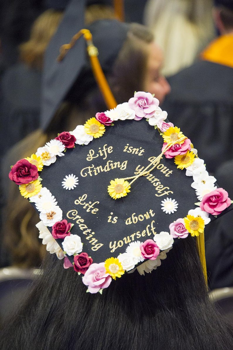 Mortarboard message: "Life isn't about finding yourself. Life is about creating yourself." 