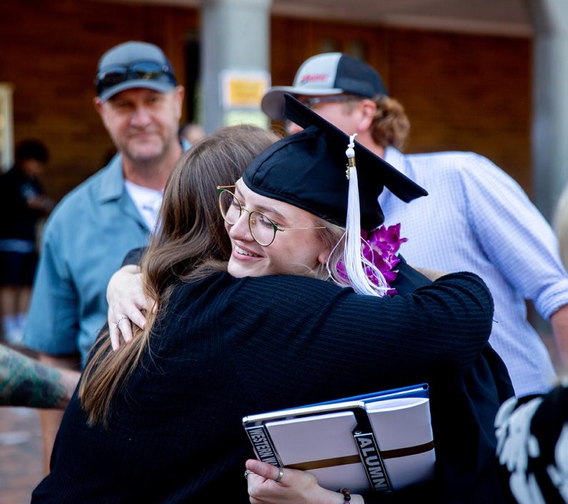 A new alum gets a hug from family