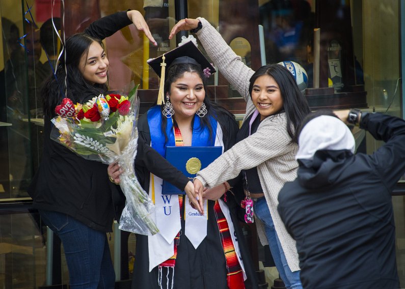 A family celebrates their new grad