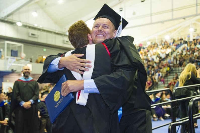 a graduate receives a hug