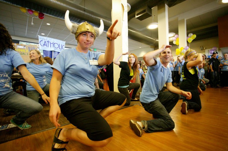 Western Washington University students Lauren Squires, Linnea Ingalls and Colin Watrin perform a flash mob dance during the Red Square Info Fair on Sept. 20, 2010, in the Viking Union Multipurpose Room, where the info fair took place because of rain. Phot