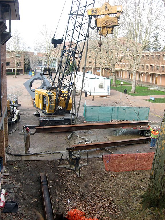 Workers install pilings for a new stairwell in Miller Hall. Photo by Debra Sams | WWU
