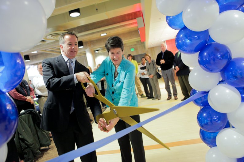 Eileen Coughlin, senior vice president and vice president for Enrollment and Student Services at Western and Aramark regional VP Chris Gossard make the ceremonial cut for the grand opening of the newly expanded student spaces in The Atrium on Wednesday, O