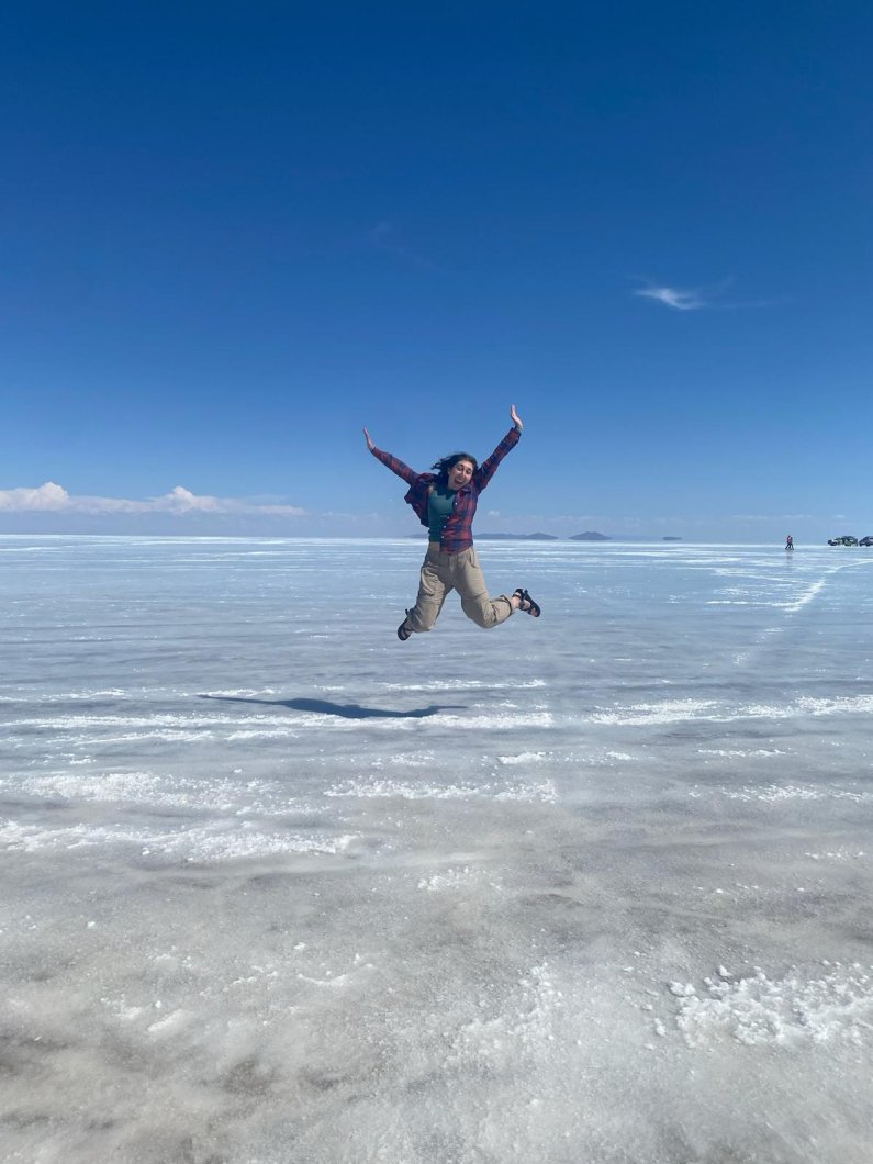 A student jumps into the air at a dry salt flat in Bolivia