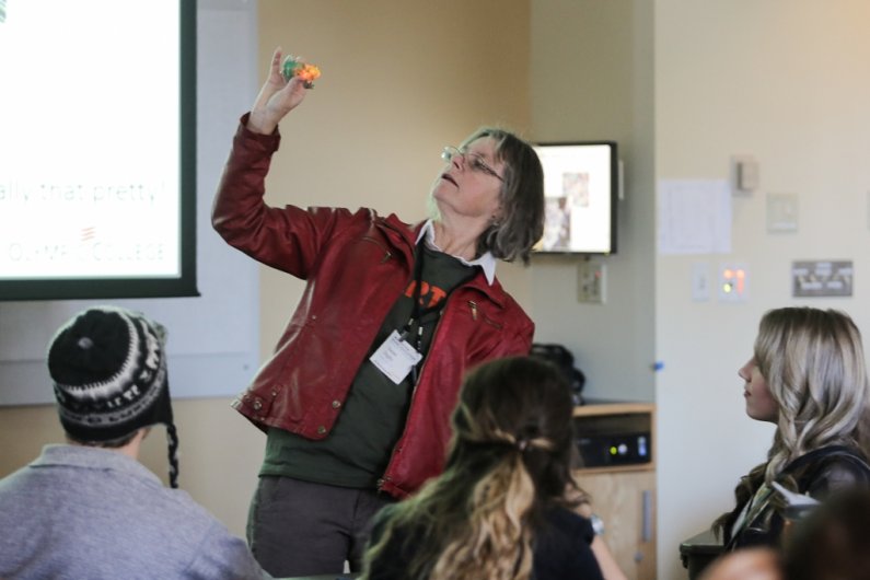Susan Digby, a geography instructor at Olympic College, shows a light-up plastic toy frog found during beach cleanup programs in the Salish Sea area during a breakout session at the Washington Higher Education Sustainability Conference at Western Washingt