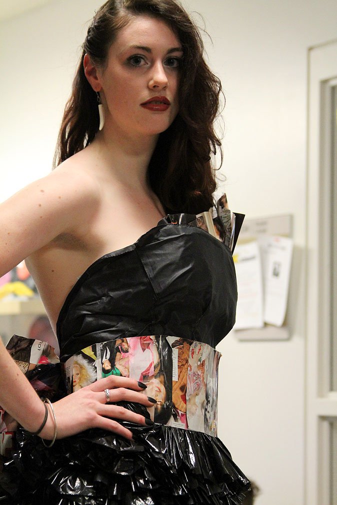 Elizabeth Kunkle, a junior in the industrial design program, models a trash fashion dress of plastic bags and magazine pages in a preview for the upcoming Trash Fashion Show in April. Photo by Becky Tachihara | University Communications intern
